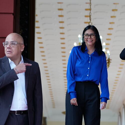 Venezuela's acting President Delcy Rodriguez, center, smiles flanked by Interior Minister Diosdado Cabello, right, and National Assembly President, her brother, Jorge Rodriguez, as they prepare ot make a statement in Caracas, Venezuela, Wednesday, Jan. 14, 2026. (AP Photo/Ariana Cubillos)