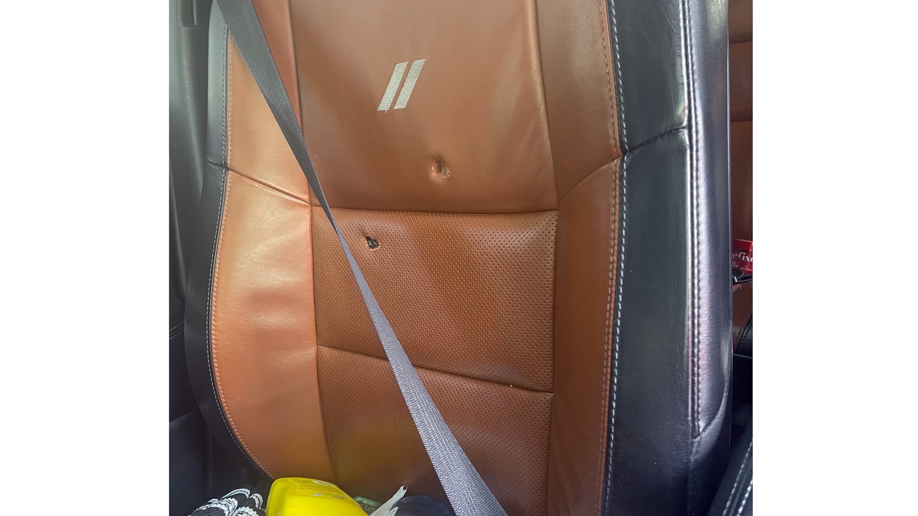 This image provided by Elizabeth Paige White shows bullet holes in a seat in a vehicle of Phillip M. Brown after a Homeland Security Investigations agent fired shots Oct. 17, 2025, in Washington, during a traffic stop. (Elizabeth Paige White via AP)