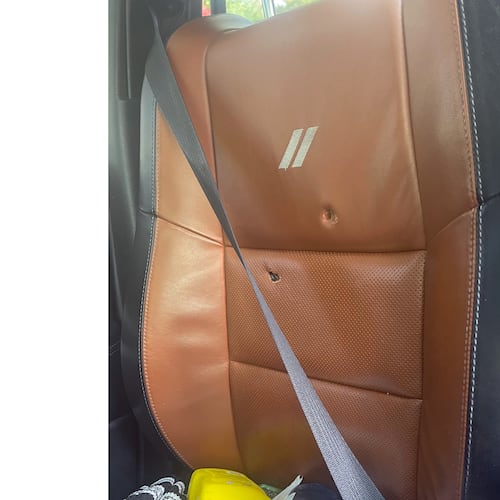 This image provided by Elizabeth Paige White shows bullet holes in a seat in a vehicle of Phillip M. Brown after a Homeland Security Investigations agent fired shots Oct. 17, 2025, in Washington, during a traffic stop. (Elizabeth Paige White via AP)