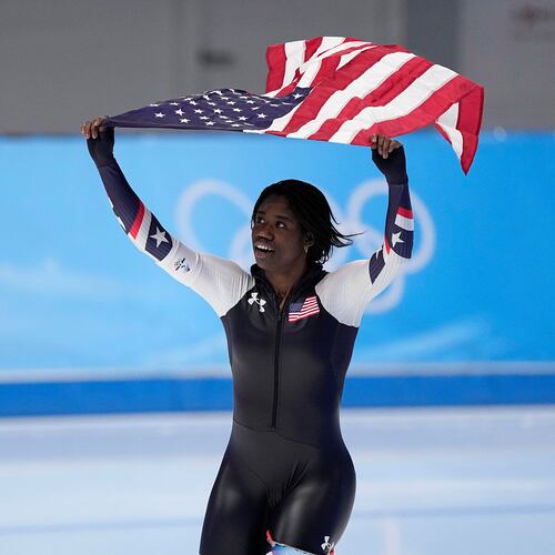FILE - Erin Jackson of the United States hoists an American flag after winning the gold medal in the speedskating women's 500-meter race at the 2022 Winter Olympics, Sunday, Feb. 13, 2022, in Beijing. (AP Photo/Sue Ogrocki, file)
