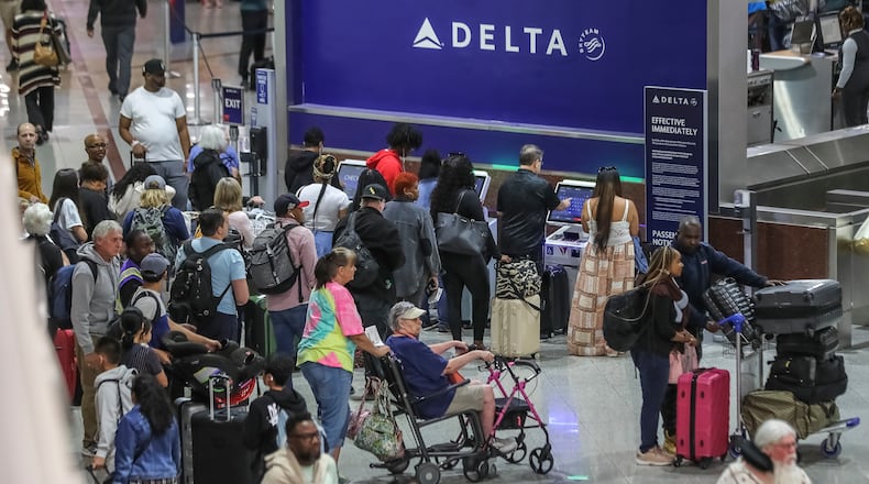 May 25, 2023 Hartsfield-Jackson International Airport: Here travelers surge at the South Terminal inside the airport Thursday morning, May 25, 2023 where Large crowds are expected to pass through Hartsfield-Jackson International Airport throughout the Memorial Day weekend. (John Spink / John.Spink@ajc.com)