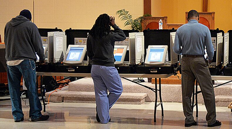 A steady stream of voters comes in to cast their ballots at the polling place at the Crossroads Presbyterian Church in Stone Mountain early on Election Day, Tuesday, November 4, 2014.