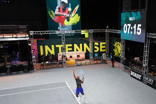 Erik Graves hits a serve during an Intennse Challenge Series match at the Electric Owl Studios. The studios filled all the requirements of the tennis league. (Miguel Martinez/AJC)