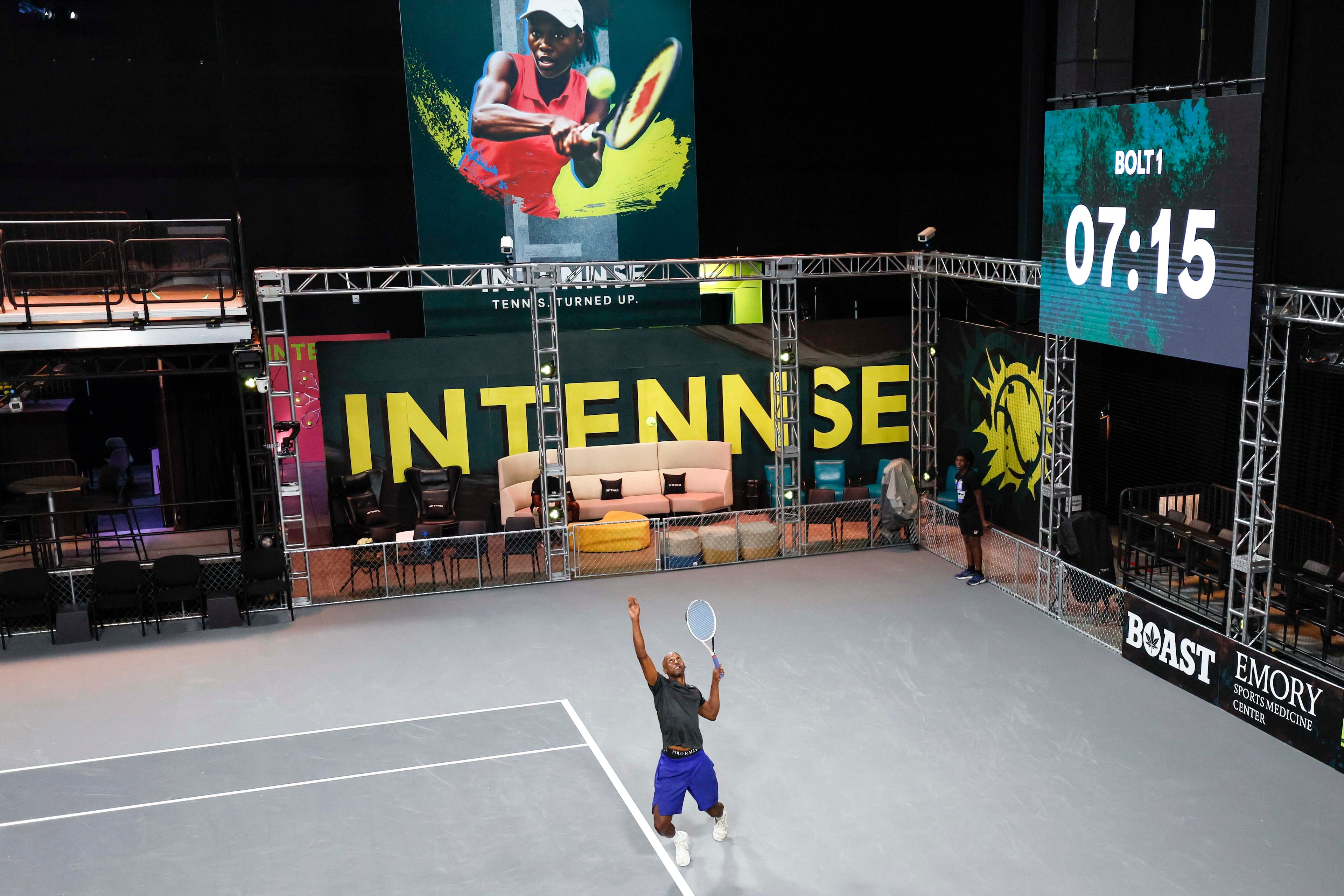Erik Graves hits a serve during an Intennse Challenge Series match at the Electric Owl Studios. The studios filled all the requirements of the tennis league. (Miguel Martinez/AJC)