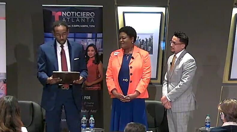 Atlanta mayoral candidates (left to right) Andre Dickens, Felicia Moore and Antonio Brown read a proclamation in recognition of Hispanic Heritage Month during a candidate forum on Tuesday, October 5 2021.