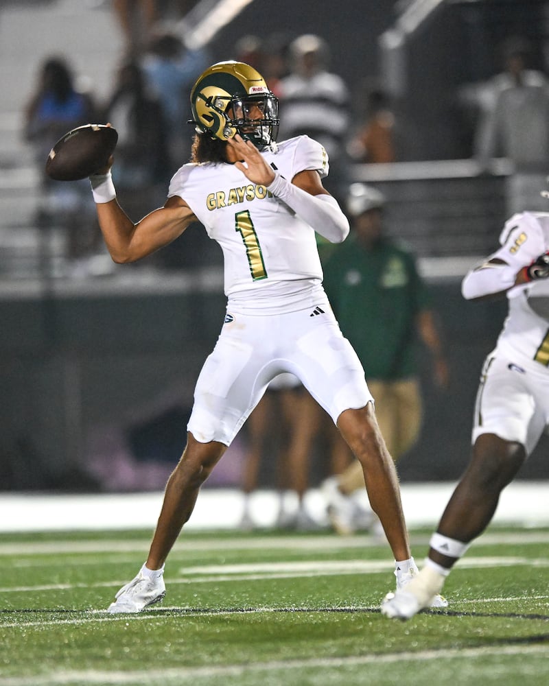 Grayson quarterback Travis Burgess drops back for a pass to a receiver during the second half of play Friday, August 15, 2025. (Daniel Varnado for the AJC)