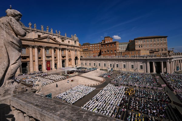People attend a mass presided over by Vatican Secretary of State, Cardinal Pietro Parolin on the second of nine days of mourning for late Pope Francis in St. Peter's Square, at the Vatican, Sunday, April 27, 2025. (AP Photo/Andreea Alexandru)