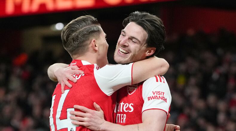Arsenal's Viktor Gyoekeres and Arsenal's Declan Rice celebrate after Brighton's Georginio Rutter scored an own goal during the English Premier League soccer match between Arsenal and Brighton and Hove Albion in London, Saturday, Dec. 27, 2025. (AP Photo/Kirsty Wigglesworth)