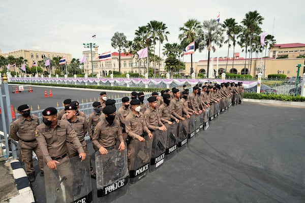 Thai policemen hold shields as anti-government protesters gather in front of Government house demanding Thailand's Prime Minister Paetongtarn Shinawatra resign in Bangkok, Thailand, Thursday, June 19, 2025, (AP Photo/Sakchai Lalit)