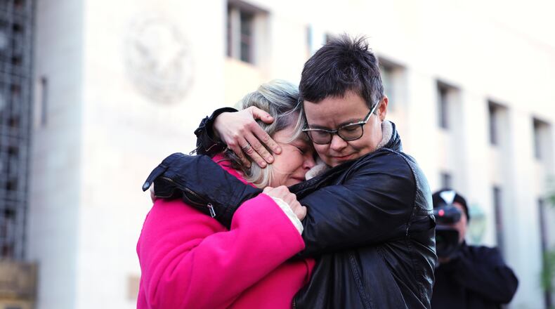 Lennon Flowers, right, Project Director of The Parents' Network hugs Lori Schott, mother of Annalee Schott, outside a landmark trial over whether social media platforms deliberately addict and harm children, Wednesday, Feb. 18, 2026, in Los Angeles. (AP Photo/Ryan Sun)