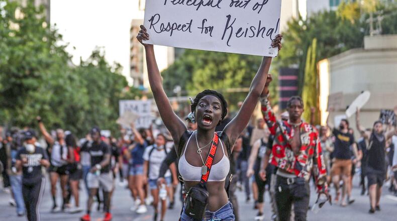 May 31, 2020 -  Atlanta -  A protester holds a sign referring to her peaceful protest with respect for Atlanta's Mayor Keisha Lance Bottoms during a march down Spring Street in Midtown. This group of protesters peacefully walked from Centennial Olympic Park to the 17th street bridge in Atlanta. They were guided by police officers.  Protestors near Centennial Olympic park as protests continued for a third day.  Protests over the death of George Floyd in Minneapolis police custody continued around the United States, as his case renewed anger about others involving African Americans, police and race relations.   Alyssa Pointer / alyssa.pointer@ajc.com