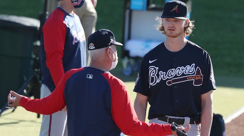 Braves pitching coach Rick Kranitz confers with right-hander Mike Soroka, coming back from a torn right Achilles tendon, during his morning pitching session at spring training on Thursday, Feb. 25, 2021, in North Port.   Curtis Compton / Curtis.Compton@ajc.com”