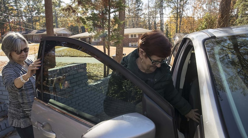 Melissa Staton (left) helps Linda Wayman (right) into her car as they prepare to head to Piedmont Fayette hospital for Linda's chemotherapy treatment appointment, Monday, November 25, 2019. Melissa has been driving for the American Cancer Society's Road To Recovery program for about 2 years. She has been transporting Luda for more than 2 months. (Alyssa Pointer/Atlanta Journal Constitution)