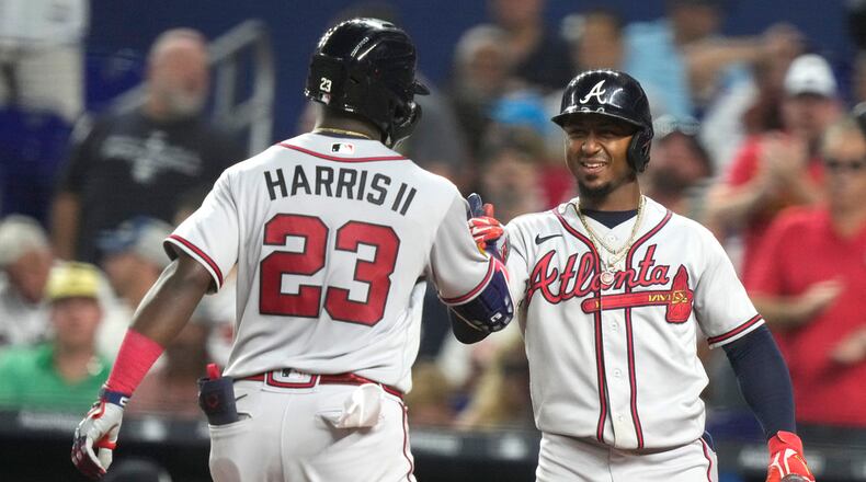 Atlanta Braves' Michael Harris II (23) is met by Ozzie Albies after hitting a solo home run during the fifth inning of a baseball game against the Miami Marlins, Saturday, Sept. 16, 2023, in Miami. (AP Photo/Lynne Sladky)