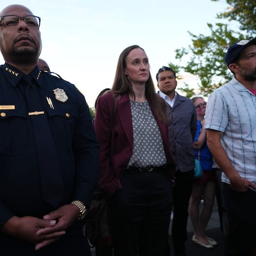 Seattle Mayor Katie Wilson, center, and Seattle Police Chief Shon Barnes, left, attend the vigil for victims the day after a shooting at Seattle Center during the Bite of Seattle food festival, Monday, July 27, 2026, in Seattle. (AP Photo/Lindsey Wasson)