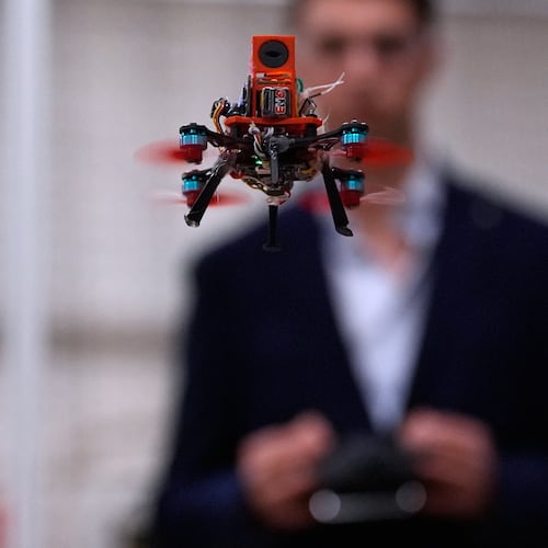 Colin Balfour, a sophomore studying robotics engineering, flies a small drone at a laboratory at the Worcester Polytechnic Institute, Monday, Oct. 20, 2025, in Worcester, Mass. (AP Photo/Charles Krupa)