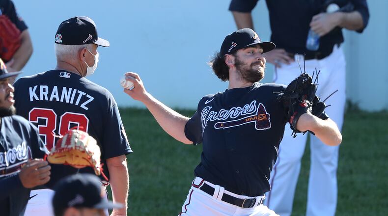022721 North Port: Atlanta Braves pitching coach Rick Kranitz gets a close look as Ian Anderson delivers during an early morning session at CoolToday Park on Saturday, Feb. 27, 2021, in North Port.   Curtis Compton / Curtis.Compton@ajc.com”