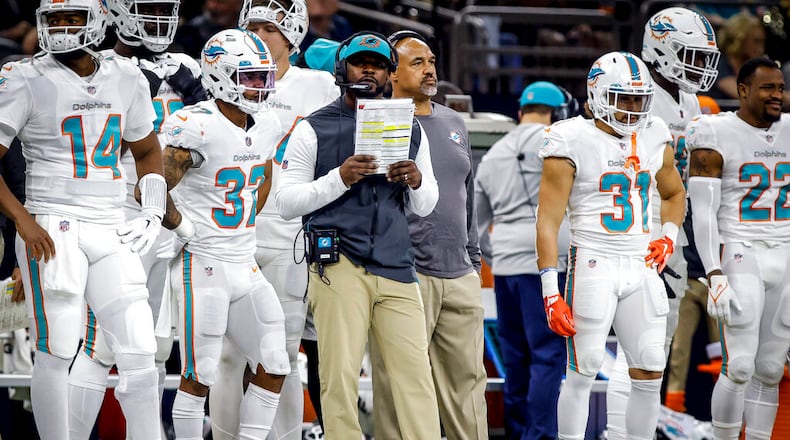 FILE - Miami Dolphins head coach Brian Flores, center, reacts to a call during an NFL football game against the New Orleans Saints, Monday, Dec. 27, 2021, in New Orleans. (AP Photo/Tyler Kaufman, File)
