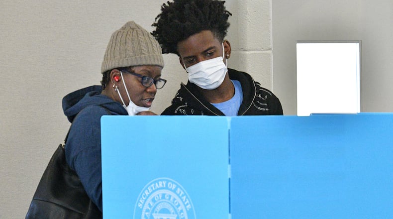October 22, 2022 Stone Mountain - Linda Settles talks with her son Channing Settles, 18, who is a first time voter, before they cast their ballots at an early voting location in Mountain Park Activity Building in Stone Mountain on Saturday, October 22, 2022. A record-breaking week of early voting continues Saturday, the first weekend voting day of the general election season. Some 729,029 people cast ballots Monday through Friday, far surpassing the 488,177 people voted during the same period in the 2018 midterm election. (Hyosub Shin / Hyosub.Shin@ajc.com)