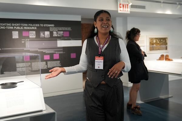 Museum Educator Ambassador Gentry Quinones, a public housing resident, talks about an exhibit at the National Public Housing Museum, built in the last remaining building of the 1930s WPA-era Jane Addams Homes, Wednesday, March 19, 2025, in Chicago. (AP Photo/Erin Hooley)