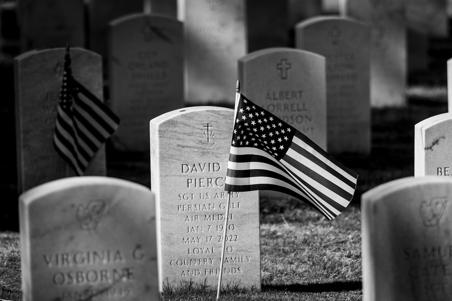 One of the many American flags is planted at the Georgia National Cemetery during the Observances of Memorial Day event on Saturday, May 27, 2023,  (Steve Schaefer/steve.schaefer@ajc.com)