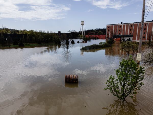 In an aerial view, a bourbon barrel floats on the floodwaters of the Buffalo Trace Distillery on Monday, April 7, 2025, in Frankfort, Ky. (AP Photo/Jon Cherry)