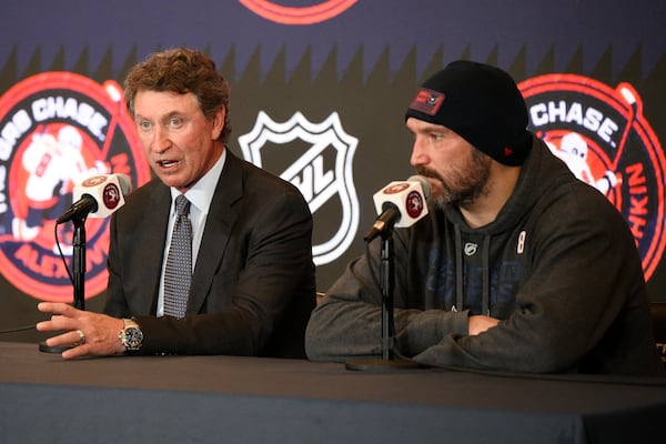 Former NHL player Wayne Gretzky, left, with Washington Capitals Alex Ovechkin, right, during a press conference after an NHL hockey game in which Ovechkin tied Gretzky's NHL career goals record of 894th goals, Friday, April 4, 2025, in Washington. (AP Photo/Nick Wass)