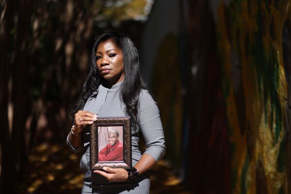 Monteria Robinson holds a photo of her son, Jamarion Robinson. (Miguel Martinez/AJC 2021) 