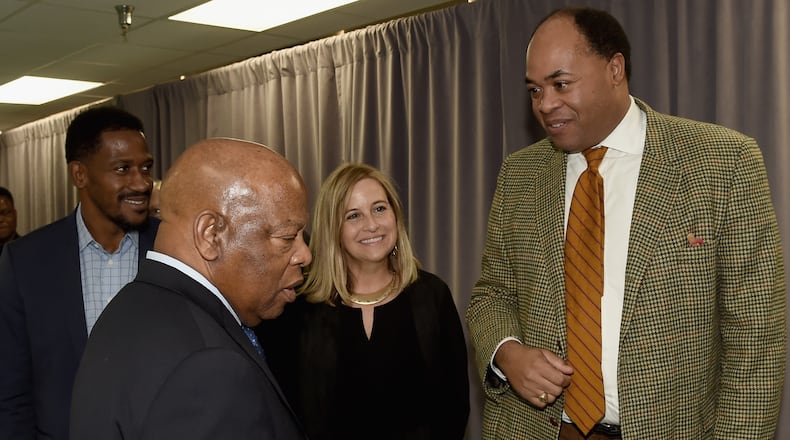 Michael Collins, U.S. Rep. John Lewis' longtime chief of staff, stands in the back left corner in Nashville last year along with Lewis, the city's mayor, Megan Berry, and attorney David Ewing. (Photo by Rick Diamond/Getty Images)
