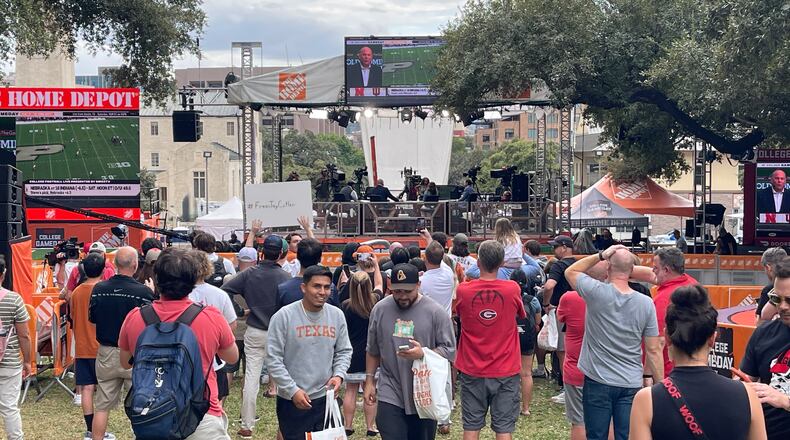 Texas students and a smattering of Georgia fans gather on the hill behind the University of Texas' famous Main Building (aka Texas Tower) on Friday afternoon to watch ESPN college football analysts talk about Saturday's matchup between the No. 5 Bulldogs and No. 1 Texas in Austin. (Photo by Chip Towers/ctowers@ajc.com)