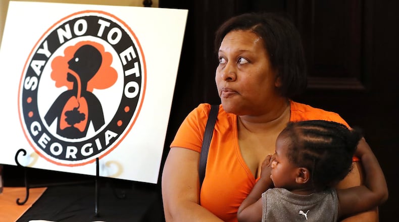 Covington resident Denise Williams holds her 1-year-old godson Davion Petty while attending the Town Hall presentation on ethylene oxide gas from the nearby Becton Dickinson plant. Curtis Compton/ccompton@ajc.com