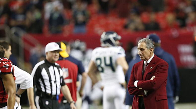 Atlanta Falcons team owner Arthur Blank stands on the field before the first half of the NFC divisional playoff NFL football game against the Seattle Seahawks, Sunday, Jan. 13, 2013, in Atlanta.