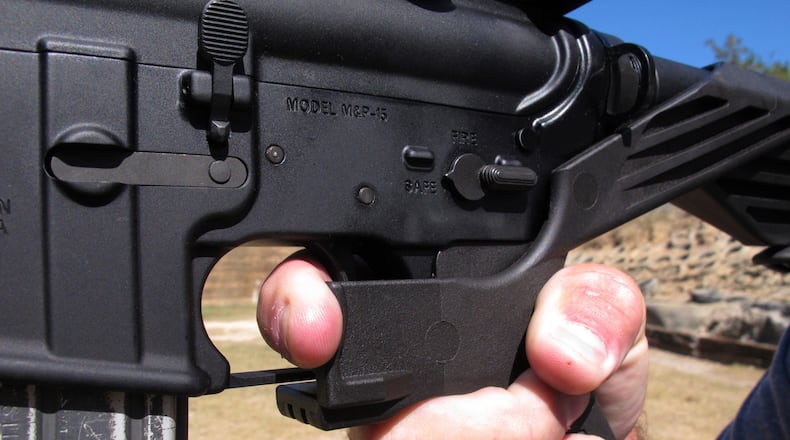 Shooting instructor Frankie McRae demonstrates the grip on an AR-15 rifle fitted with a bump stock at his 37 PSR Gun Club in Bunnlevel, N.C. AP file/Allen G. Breed