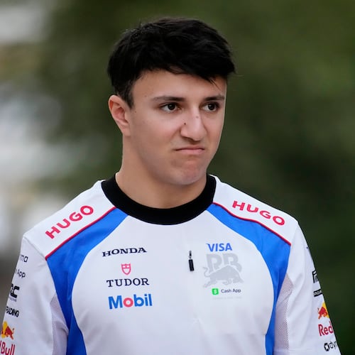 Racing Bulls driver Isack Hadjar of France walks through the paddock at the Lusail International Circuit ahead of the Qatar Formula One Grand Prix, in Lusail, Qatar, Thursday, Nov. 27, 2025. (AP Photo/Darko Bandic)