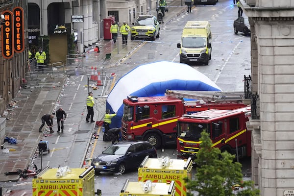A tent is erected by police at the site of an incident on Water Street near the Liver Building in Liverpool after a car collided with pedestrians during the Premier League winners parade, in Liverpool, England, Monday May 26, 2025. (Danny Lawson/PA via AP)