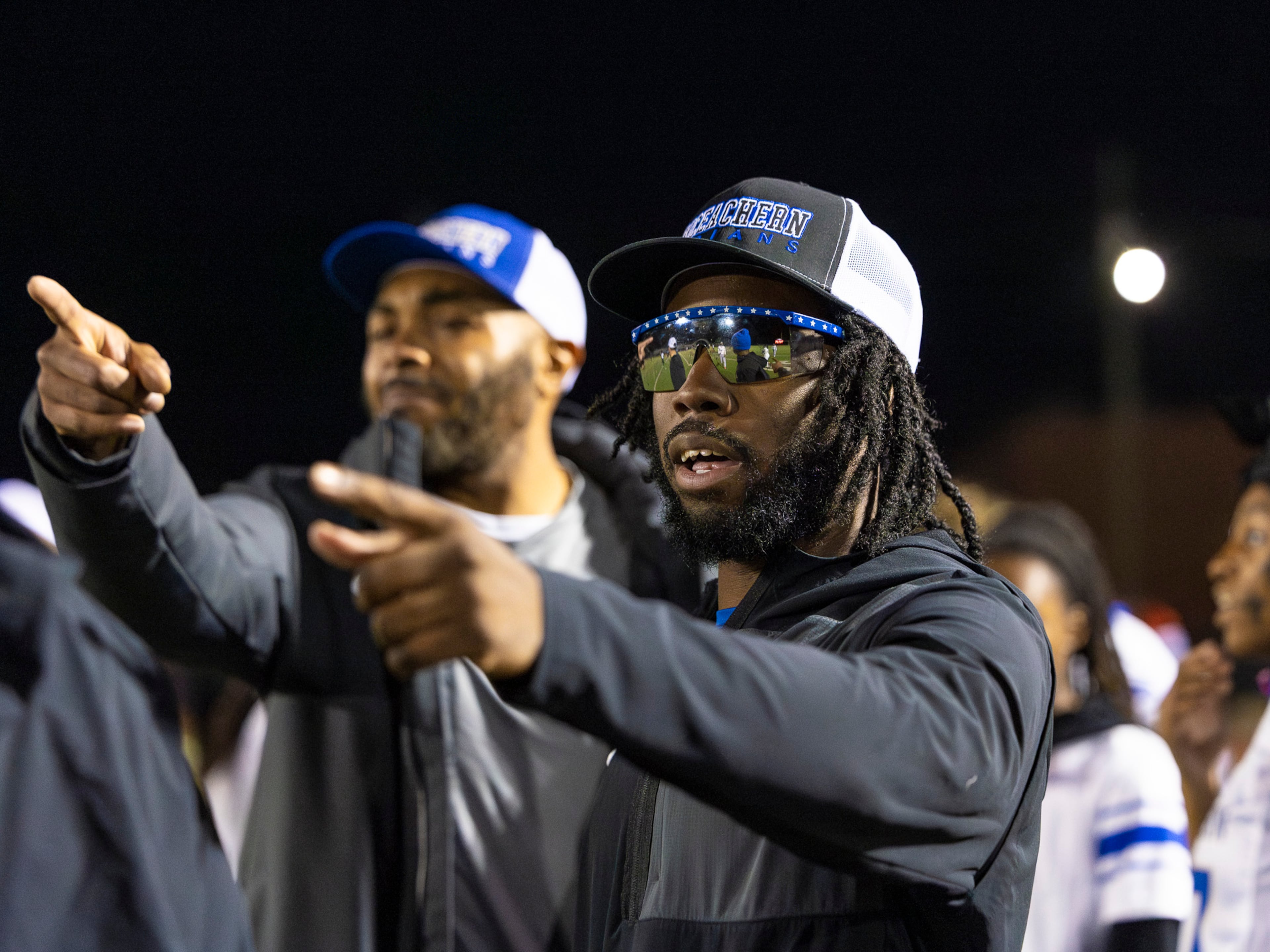 Nigel Talton (right) helped coach the McEachern High School flag football team to a win on Monday. (Oscar Guevara Saenz for the AJC)