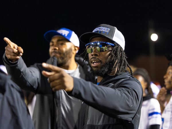 Nigel Talton (right) helped coach the McEachern High School flag football team to a win on Monday, Nov. 17, 2025. (Oscar Guevara Saenz for the AJC)