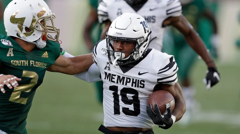 Memphis running back Kenneth Gainwell (19) pushes off South Florida defensive back Nick Roberts (2) during the first half Saturday, Nov. 23, 2019, in Tampa, Fla. (Chris O'Meara/AP)