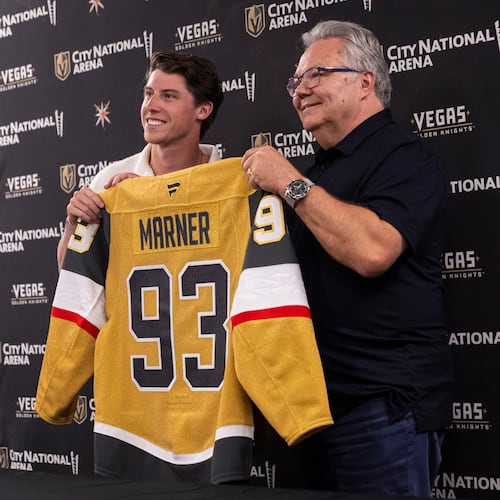 FILE - Newly-acquired Golden Knights forward Mitch Marner, left, poses for a photo with his jersey alongside general manager Kelly McCrimmon, July 1, 2025, in Las Vegas. (Chase Stevens/Las Vegas Review-Journal via AP, File)