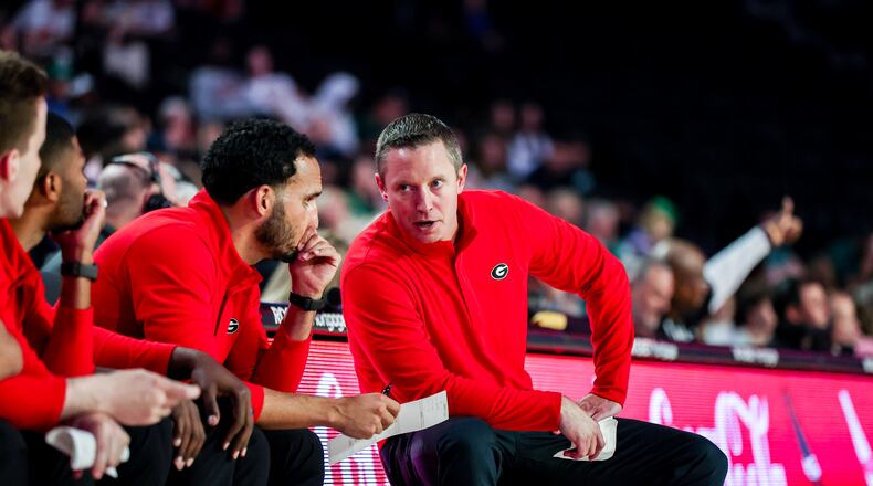 Georgia's first-year coach Mike White (R) confers with his assistant coaches during the Bulldogs' exhibition game against Georgia College at Stegeman Coliseum in Athens, Ga., on Tuesday, Nov. 1, 2022. (Photo by Tony Walsh/UGA Athletics)