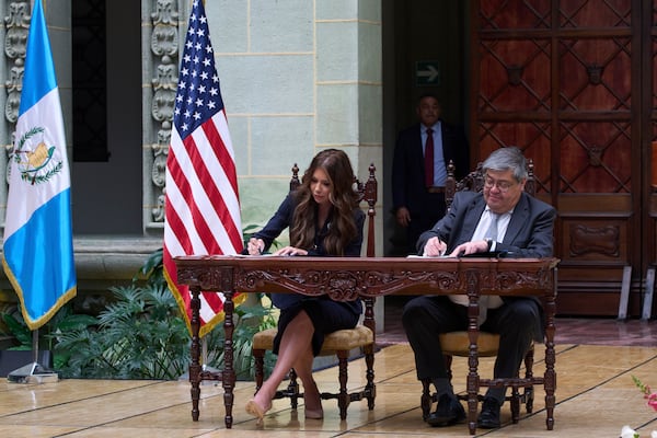 U.S. Homeland Security Secretary Kristi Noem, left, and Guatemalan Interior Minister Francisco Jimenez sign a security program agreement at the National Palace in Guatemala City, Thursday, June 26, 2025. (AP Photo/Moises Castillo)