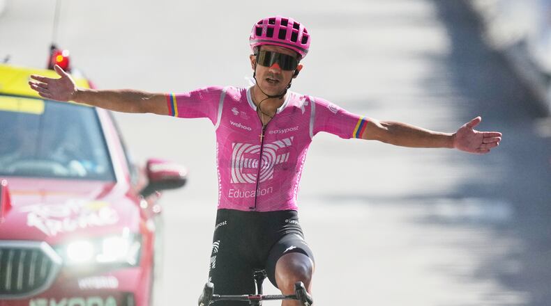 Ecuador's Richard Carapaz celebrates as he crosses the finish line to win the eighteenth stage of the Tour de France cycling race, with start in Voiron and finish in Orcieres-Merlette, France, Thursday, July 23, 2026. (AP Photo/Mosa'ab Elshamy)