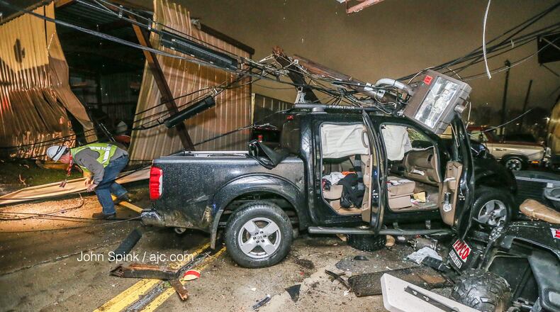 A pickup truck crashed into a business and knocked down power lines on Moreland Avenue early Monday.