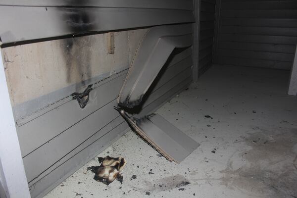 Two fires at an apartment complex near Norcross damaged vinyl siding, left concrete smoke stains and burned pine straw. (Courtesy of Gwinnett County)