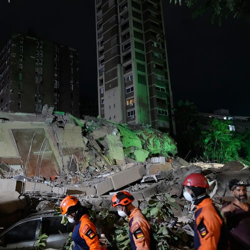 Rescue workers search through the rubble of a collapsed building after an earthquake in Caracas, Venezuela, Thursday, June 25, 2026. (AP Photo/Ariana Cubillos)