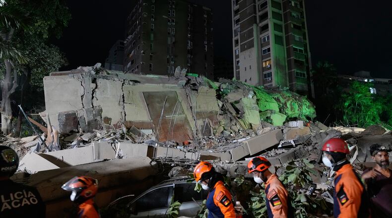 Rescue workers search through the rubble of a collapsed building after an earthquake in Caracas, Venezuela, Thursday, June 25, 2026. (AP Photo/Ariana Cubillos)