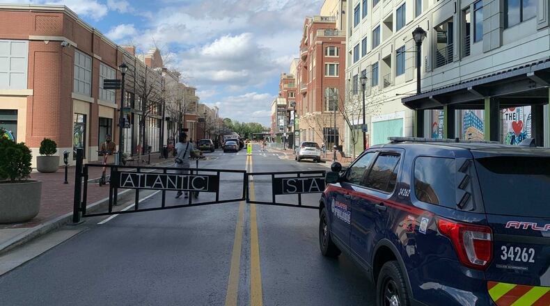A woman who was walking nearby was shot Sunday when gunfire erupted at Atlantic Station.
