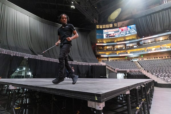 After the flooring is in place, Conversion Coordinator Richard Campbell does what he calls a “rain dance” on the floor to see if they are level so he can make final adjustments to the main stage for the next concert at State Farm Arena, Thursday, October 2, 2025, in Atlanta. The crew was working on creating a stage for the Friday, Oct. 3 Maxwell concert. (Jason Getz/AJC)