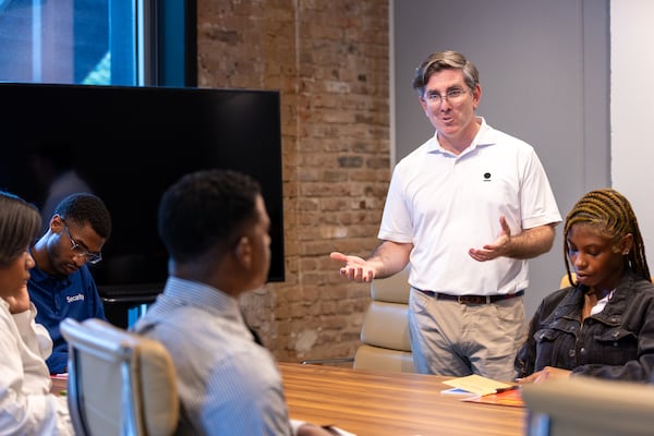 Michael Chanin, CEO of Cherry Street Energy, speaks to former foster youth interested in a solar apprenticeship class at Cherry Street Energy’s office in Atlanta on Friday, August 16, 2024. (Arvin Temkar / AJC)