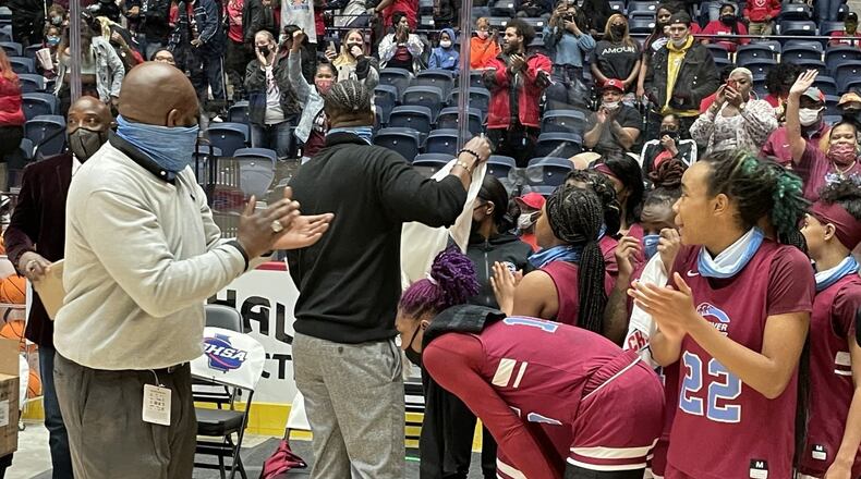 Carver-Columbus coach Anson Hundley (left) applauds his team's effort after the Tigers defeated Cairo 70-54 in the Class 4A championship game Wednesday, March 10, 2021, at the Macon Coliseum.